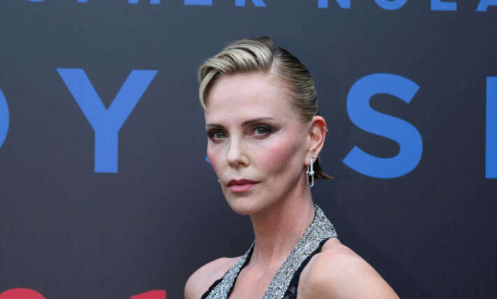 Charlize Theron, 50, steals the show in plunging lace gown and $50k jewels