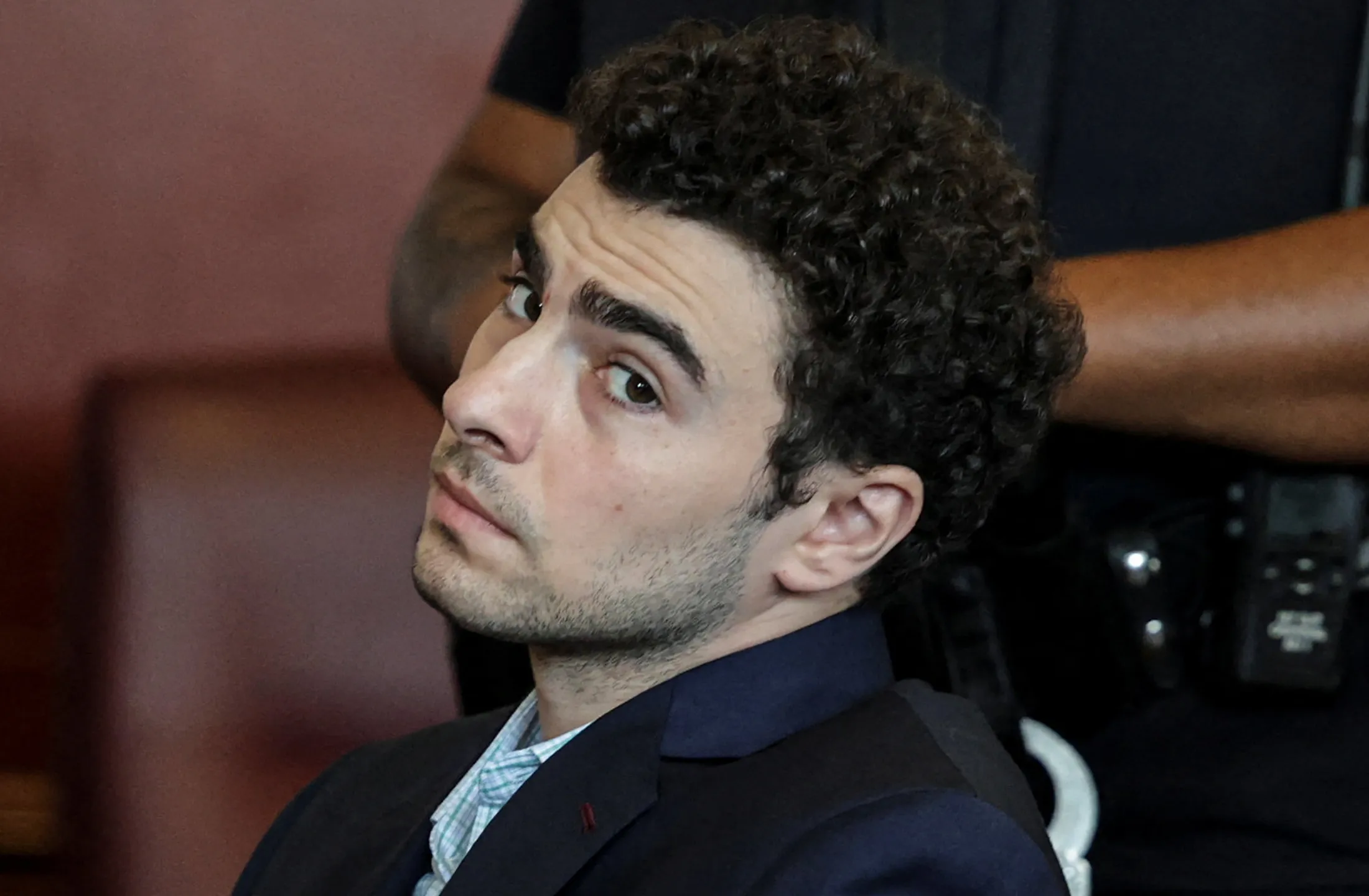 What is an open plea, which Luigi Mangione entered in court?