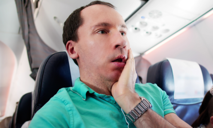 Parents put headphones on during flight—passenger stunned by what follows