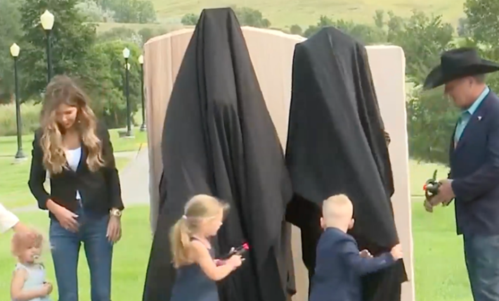 Outrage as Kristi Noem unveils bizarre bronze statue of herself with unexpected animal