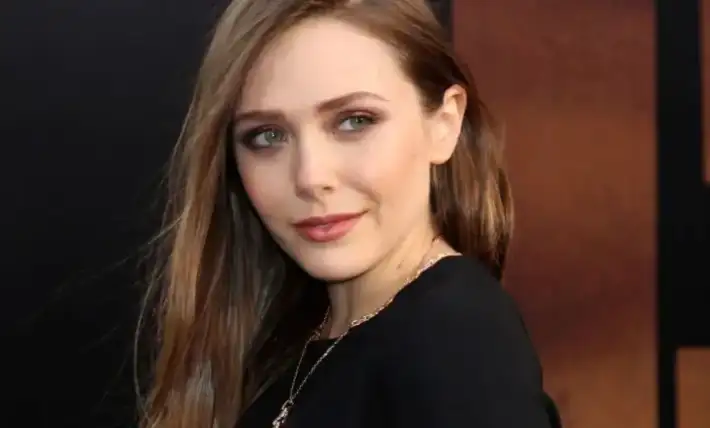 Elizabeth Olsen owns the spotlight in a curve-hugging black dress in a throwback