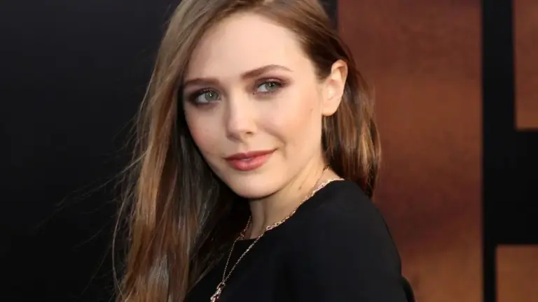 Elizabeth Olsen owns the spotlight in a curve-hugging black dress in a throwback