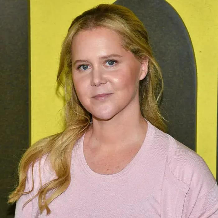 Amy Schumer displays her 50-lb weight loss in a gingham belted mini dress at the US Open
