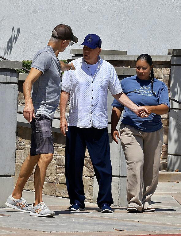 Bruce Willis supported by two assistants after rare church outing as wife shares ‘guilt’
