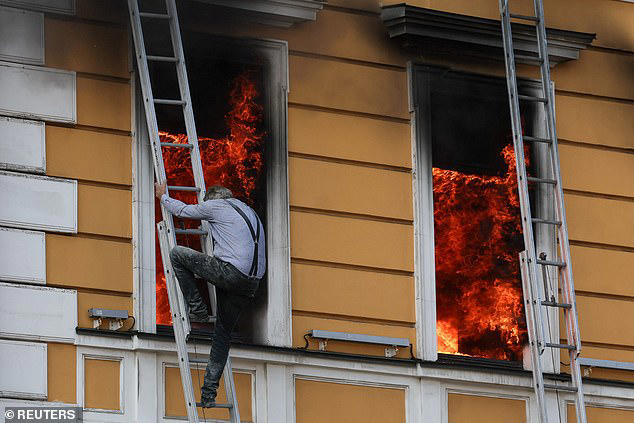 Russian drone slams into Kyiv science HQ with trapped victims climbing out of windows to escape fire